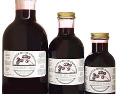 three bottles of elderberry family syrup on a white background