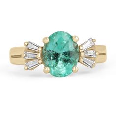 A unique glorious emerald and diamond ring. The center stone carries almost two carats of a stunning, oval-cut Colombian emerald. The gemstone displays a bright spring green color and very good eye clarity. Set in a four-prong setting, accented by three petite baguette-cut diamonds on either side. Carefully set and crafted in a 14K yellow gold setting. Setting Style: Prong Setting Material: 14K Yellow Gold Setting Weight: 4.4 Grams Main Stone: Emerald Shape: Oval Cut Weight: 1.98-Carats Clarity: Oval Yellow Gold Ring With Baguette Diamonds, Modern Emerald Baguette Cut Ring, Modern Oval Brilliant Cut Emerald Ring, Oval Green Baguette Diamond Jewelry, Oval Green Jewelry With Baguette Diamonds, Green Oval Baguette Diamond Jewelry, Green Oval Jewelry With Baguette Diamonds, Timeless Oval Ring With Baguette Diamonds, Timeless Oval Rings With Baguette Diamonds