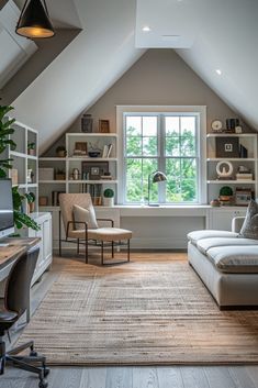 a living room filled with furniture and bookshelves under a slanted ceiling above a window