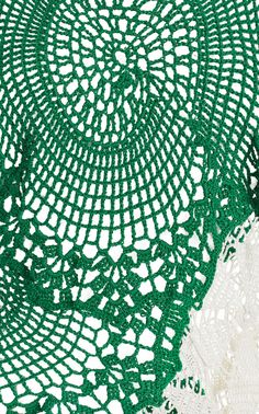 green crocheted doily on white background