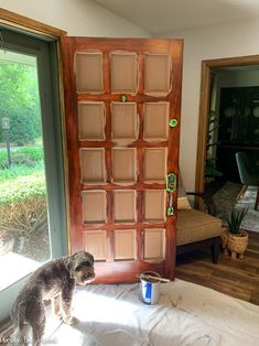 a dog is standing in front of a door and looking at the outside through it