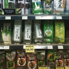 an assortment of green teas on display in a store