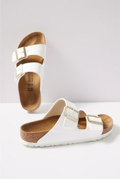 Clean white leather gives an eye-catching update to these iconic Birkenstock sandals, featuring an adjustable two-strap design and a comfy cork footbed. At the heart of every Birkenstock design is the legendary footbed. The details are all in the design; each element of the footbed serves a purpose to encourage proper foot health. The result is signature style coupled with all-day comfort. White Slides With Cork-bed Midsoles For Spring, Summer Double Strap Sandals With Branded Heel, White Leather Footbed Sandals For Summer, White Flat Leather Footbed Sandals, White Leather Footbed Open Toe Sandals, White Double Strap Sandals With Cork-bed Midsoles, White Closed Toe Footbed Sandals With Buckle Closure, White Slides With Buckle Closure For Spring, White Leather Footbed Sandals With Double Strap