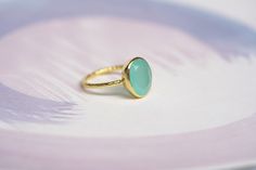 A dainty band hand-made from 18kt gold plated sterling silver has a light spiralling texture and is set with a beautiful faceted Aqua Chalcedony. This piece was crafted from a unique wax form created in our Devon studio. Wearing chalcedony jewellery is thought to aid self-confidence and remove self-doubt. It is also a perfect alternative March birthstone gift. This ring comes packaged in our Isla Silver gift box making this an ideal gift for a loved one or yourself. About This Ring:  Chalcedony Yellow Gold Chalcedony Ring Gift, Elegant Green Chalcedony Rings, Handmade Elegant Green Moonstone Ring, Elegant Handmade Green Moonstone Ring, 18kt Gold Jewelry, Dainty Band, Silver Gift Box, Gold Vermeil Jewelry, Chalcedony Ring