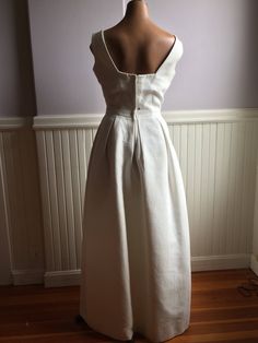 "Simply elegant white gown designed by Harry Keiser, I believe to be in the late 50's early 60's. Size 10 ( vintage 1960's sizing). Would make a lovely alternative wedding dress or formal for a 'black and white' affair. The simplicity of this dress makes it a show stopper with its square cut neckline. Totally lined with a net crinoline underneath. I believe at one time it might have had an added waist band as there are snaps and hook and eye placements in the front. I personally saw it with a wi Elegant Tea Length Wedding Gown, Elegant Tea-length Wedding Gown, A-line Wedding Maxi Dress With Pleated Bodice, A-line Pleated Bodice Maxi Dress For Wedding, Wedding Maxi Gown With Pleated Back, Wedding Gown With Pleated Back In Maxi Length, Classic Maxi Length Wedding Evening Dress, Classic Wedding Evening Dress With Pleated Bodice, Classic Maxi Length Evening Dress For Wedding