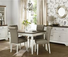 a dining room table with four chairs around it