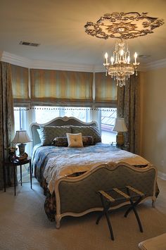 a bedroom with a chandelier and bed in it