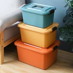 three different colored containers stacked on top of each other