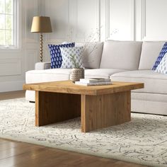 a living room with a white couch and wooden coffee table