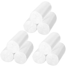 four rolls of white toilet paper sitting next to each other on top of a white surface