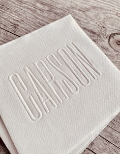 two napkins with the word california printed on them sitting on a wooden table top