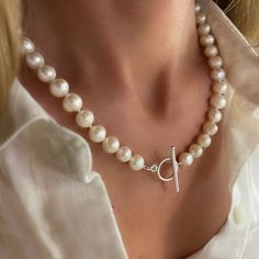 "A beautiful necklace of genuine ivory pearls, individually knotted and finished with a sterling silver Toggle Clasp.  This versatile necklace goes with everything from casual to formal -  An instant classic and great addition to any jewelry collection.  available in 16.5\", 18.5\", 20.5\" lengths.  measurements including the toggle clasp.  clasp can be worn front or back.  the pearls are cultured akoya freshwater pearls, 9-10mm, each will have its own unique variations - no two pearls are the same.  all components are Solid 925 Sterling Silver necklace also available with pearl pendant." Elegant Toggle Necklace With Sterling Silver Clasp As Gift, Elegant Toggle Necklace With Sterling Silver Clasp, Elegant Silver Necklace With Toggle Clasp, Elegant Sterling Silver Necklace With Toggle Clasp, Elegant Sterling Silver Toggle Necklace, Classic Sterling Silver Toggle Necklace, Classic Toggle Necklace With Pearl Charm For Gift, Classic Pearl Charm Toggle Necklace, Elegant Silver Toggle Necklace For Gift