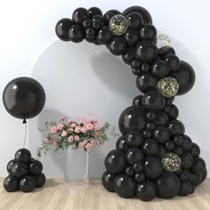 black balloons are arranged in the shape of an arch, with flowers and vases