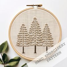 a hand embroidery pattern with trees on it