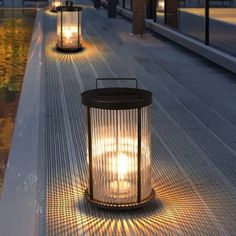 two lanterns are lit on the side of a building