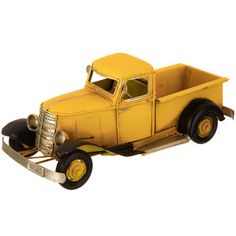 an old yellow toy truck on a white background