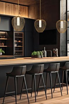 an image of a modern kitchen setting with bar stools and pendant lights hanging over the island