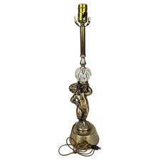 an antique brass table lamp with a glass ball on the base and a gold plated finish