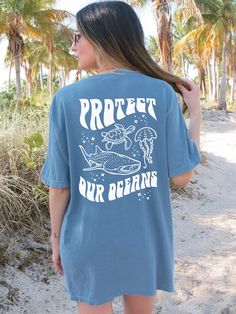 a woman wearing a blue shirt that says protect our oceans