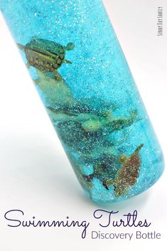 a close up of a blue tube with sea animals on it and the words swimming turtles discovery bottle