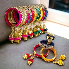 Elevate your style with our exquisite Indian Silk Thread Bangles. Expertly handcrafted with luxurious silk thread and adorned with stunning Kundan bangles, these ethnic bracelets add a touch of elegance to any outfit. Perfect for Indian weddings, these assorted Kangan with Latkan are the epitome of fashion and luxury. Free size for a comfortable fit. Material: Plastic, Silk Thread and Kundan Size: Designed as free size, these bangles offer versatility and ease of wear for women of different wris Silk Thread Bangle With Dori Work For Festivals, Festive Handwork Bangle, Multicolor Silk Thread Bangle As Gift, Multicolor Silk Thread Bracelets For Gifts, Multicolor Silk Thread Bracelets As Gift, Gold Embroidered Bracelets For Wedding, Handwork Bangle Bracelets For Festivals, Handwork Bangle Bracelets For Diwali, Gold Silk Thread Bracelets For Diwali