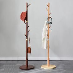 two coat racks with coats hanging on them