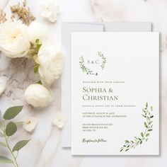 wedding stationery with white flowers and greenery on marble background, close up view