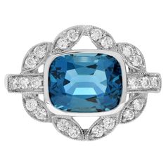 Make a statement with this Art Deco inspired London Blue Topaz Engagement Ring. The emerald cut topaz in the center is accented by shimmering diamonds. This ring, crafted in solid white gold, is perfect for those who appreciate antique and artistic jewelry. Ring Information Style: Vintage Metal: 14K White Gold Total weight: 3.70 g. (approx. total weight) US 3 – 8 available Center Gemstones Type: London Blue Topaz Shape: Emerald Cut Size: 10 x 8 mm. Number: 1 Weight: 3.90 Carat (approx. total weight) Accent Gemstones Type: Diamond Shape: Round Average Color: H Average Clarity: SI Size: 1.5 mm. Number: 22 Weight: 0.30 Carat (approx. total weight) This ring will be made to your order in 1-2 weeks, contact us to find out more. An attractive ring box is included. Most of our rings can be sized Luxury Art Deco Topaz Ring With Diamond, London Blue Topaz Engagement Ring, London Blue Topaz Engagement Rings, Number 22, Blue Topaz Engagement Ring, Modern Engagement Rings, Topaz Engagement Ring, London Blue Topaz Ring, Blue Topaz Stone