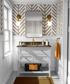 a bathroom with white cabinets and gold accents