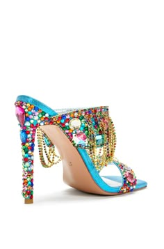 Our Envie stiletto mules are the perfect luxurious statement shoe. These feature an open toe and square cut silhouette made with a blue fabrication and colorful rhinestone embellishments all over the shoe. The front strap also includes gold chain accents draping down the shoe. These beautiful shoes would be perfect styled for a going out look! Heel Height: 4.75" Stained Glass Shoes, Thick Heeled Shoes, Shoe Goals, Glass Shoes, Jeweled Shoes, Shoes Heels Classy, Cute Shoes Heels, Chain Dress, Chic Heels