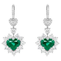 18kt white gold heart shape earrings weighing 8.16 cts; heart and round shape diamond in a halo weighing total of 8.00 ct of white diamonds set all the way around. C. Dunaigre Emerald Heart Earrings, Luxury Heart-shaped Diamond Earrings, Luxury Diamond Earrings For Valentine's Day, Luxury Heart Cut Diamond Earrings, Luxury Heart Earrings With Diamond Accents, Luxury Cubic Zirconia Heart Earrings For Formal Events, Luxury White Gold Heart-shaped Diamond Earrings, Luxury White Gold Diamond Heart Earrings, Luxury Diamond Heart Earrings In White Gold