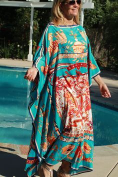 Beautiful turquoise designer print silk caftan (the color photographed more green in the outdoor light, but it is a turquoise color as the second photo shows) . Great for pool, beach, travel or lounging at home or an evening out. One size. Fits small to X-large sizes. The width is 52 inches edge to edge or 104 around the body. The length is 52 inches. Blue Bohemian Dress For Pool, Green Bohemian Kaftan With Vibrant Print, Turquoise Kaftan For Summer Beach Cover-up, Turquoise Maxi Kaftan For Summer, Turquoise Kaftan For Beach, Spring Bohemian Turquoise Kaftan, Spring Turquoise Bohemian Kaftan, Blue Silk Kaftan For Beach Cover-up, Green Vibrant Print Kaftan For The Beach