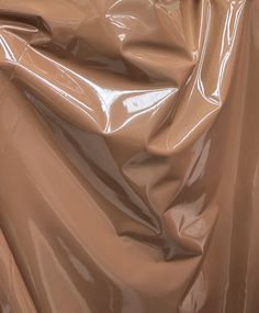 a close up view of a shiny brown material