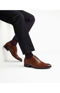 Classic and versatile, this plain-toe leather derby features simple detailing that smartly grounds any formal or semiformal look. Lace-up style Leather upper/synthetic lining and sole Imported Modern Business Casual Lace-up Shoes With Leather Sole, Business Lace-up Shoes With Textured Sole In Oxford Fabric, Business Oxford Lace-up Shoes With Textured Sole, Business Oxfords With Textured Sole And Round Toe, Business Oxfords With Textured Sole, Fitted Cap Toe Dress Shoes With Textured Sole, Semi-formal Pointed Toe Dress Shoes With Textured Sole, Formal Dress Shoes With Textured Sole And Pointed Toe, Modern Formal Lace-up Shoes With Brogue Detailing