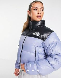 Relaxed fit with a cropped, boxy silhouette Inspired by the iconic design lines of our 1996 Nuptse Jacket Original shiny ripstop fabric for durability Non-PFC DWR finish for added water repellency 700 fill goose down offers warmth yet remains extremely compressible Oversize baffles Attached, stowable, three-piece hood packs into stand collar Exposed, two-way center front zip Secure-zip hand pockets Encased-elastic cuffs with adjustable hook-and-loop cuff tabs Hem cinch-cord for adjustability Logo on left chest and back-right shoulder Has the oversize logos of the original ’96 jacket 1996 Nuptse Jacket, Nuptse Jacket, North Face Puffer Jacket, North Face Nuptse, Cropped Puffer Jacket, Puffer Jacket Women, Women's Coats & Jackets, Jacket Women, Crop Jacket