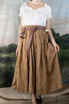 This skirt is made from a beautiful shade of ginger brown 100% linen fabric that is soft, breathable and drapey. Linen is the historically accurate choice for historical costumes, and this will add a level of authenticity to your outfit.  An elastic waistband gives the skirt a comfortable fit around your natural waist. This skirt features and elastic waistband for a comfortable fit around your waist. The length is made custom to any length you’d like. Please provide your natural waist meas Fall Daywear Skirted Bottoms, Fitted Summer Skirt With Waistband, High Waist Skirt With Waistband For Spring, Elegant Non-stretch Full Skirt Bottoms, Spring Fitted Skirt With Wide Waistband, Spring Skirt With Waistband, Spring Relaxed Skirt With Waistband, Summer Daywear Waist-length Skirt, Fitted Beige Maxi Skirt For Daywear