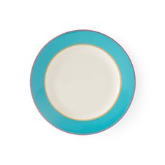 a blue and white plate sitting on top of a white table next to a wall