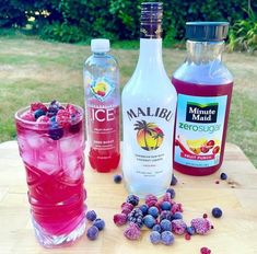 three different types of drinks sitting on top of a wooden table next to each other