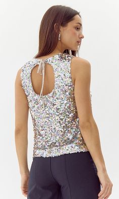 Sleeveless blouse made in muticolored sequins. This piece is tied off in the back. Sequin Top Sleevless Tie Back Lined Length: 21 3/4" Chest: 17 3/4" Self: 100% Polyester Lining: 97% Polyester, 3% Spandex Hand wash in cold water. Lay flat to dry. Low iron. Model is wearing a size small Style #: G249T7072 Sweater Jumpsuit, Sequin Top, Tie Backs, Sleeveless Blouse, New Shop, Fashion Games, Design Trends, Rompers, How To Wear