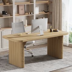 a desk with two computers on it in front of a bookshelf filled with shelves