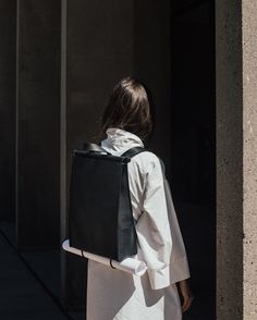 A professional and adaptable backpack for creators on the move. Handcrafted in Montreal from our signature matte black pebbled cowhide, Sac à Dos is a multi-functional backpack made of 100% genuine pebbled leather. Our new adjustable "peek-a-boo" bungee straps hold large format drawings, architectural plans, small camera stands or a light yoga mat. Features our signature stained wood and bungee cord closure with a matte black snap. Standard 36in / 90 cm or tall 40in / 100 cm removable strap is a Backpack Photoshoot, Minimalistic Backpack, Backpack Minimalist, Backpack Design, Aesthetic Backpack, Multifunction Bag, Camera Backpack, Minimalist Backpack, Minimalist Bag