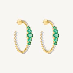 Major statement alert. These phenomenal hoops featuring substantial bright green emeralds and diamond hoop earrings are great for day or an evening out. Set in 14k yellow gold. Total emerald weight: 3.15ct Total diamond weight: 3.05ct Diamond color: G-H, Diamond clarity: VS Dimensions: 1 1/2" w x 1 1/2" l Fine Jewelry Emerald Hoop Earrings In Green, Green Diamond Hoop Earrings Fine Jewelry, Green Emerald Hoop Earrings In Fine Jewelry Style, Emerald Green Hoop Earrings Fine Jewelry, Green Emerald Hoop Earrings Fine Jewelry, Luxury Green Hoop Earrings, Luxury Green Hoop Jewelry, Green Emerald Hoop Earrings For Anniversary, Green Hoop Earrings With Prong Setting