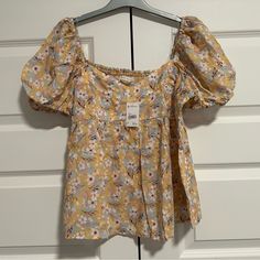 Brand: Versona - Becool Size: Large Condition: New With Tag Color: Yellow With Flowers Measurements Are Approximate, Please See Photos Made In Vietnam 50% Cotton 50% Rayon Cute Floral Print Short Sleeve Blouse, Cute Short Sleeve Floral Print Blouse, Cute Cotton Top With Ditsy Floral Print, Cute Cotton Tops With Ditsy Floral Print, Cute Tops With Ditsy Floral Print For Day Out, Cute Yellow Spring Blouse, Cute Floral Print Spring Tops, Cute Floral Print Tops For Spring, Cute Multicolor Floral Print Blouse