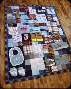 a quilt made to look like it has baby's clothes and booties on it