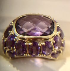 14K SOLID YELLOW GOLD Spectacular Natural Amethyst Dome Ring 5.76 cts Sz 7. Solid Yellow gold, marked 14K Natural Amethyst Ring Size: 7 Width: 5/8" Center Amethyst: 10.5 x 9mm, 4.0 cts, cushion cut Side stones: 1.76cts of 44 Round Amethyst Weight: 7.3 grams Luxury Faceted Amethyst Ring For Formal Occasions, Luxury Faceted Amethyst Ring For Formal Events, Multi-stone Amethyst Ring In Yellow Gold, Luxury Faceted Gemstones For Anniversary, Formal Faceted Amethyst Ring Fine Jewelry, Exquisite Yellow Gold Amethyst Ring With Accent Stones, Elegant Faceted Amethyst Ring In Yellow Gold, Purple Faceted Ring For Formal Occasions, Formal Faceted Purple Ring