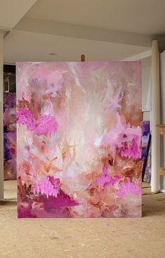 an abstract painting with pink and purple flowers in the background, on display at a museum