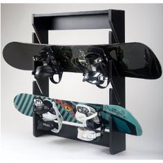 two snowboards are attached to a black rack