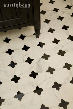 a bathroom floor with black and white designs on it