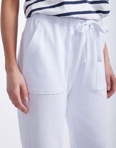 DESCRIPTION Stay effortlessly chic with the Raw Edge Lounge Pants in White by White & Co. The Label. These stylish lounge pants boast a relaxed fit with a straight leg and raw hem, adding a contemporary edge to your casual wardrobe. The elastic waistband with a drawstring tie provides a secure and comfortable fit, while the large front patch pockets enhance both functionality and style. Perfect for lounging around the house or casual days out, these French Terry pants are a versatile addition to Casual Straight Leg Pants With Bottom Hem, White Bottoms With Straight Hem For Everyday, Everyday White Bottoms With Straight Hem, Lounging Bottoms With Pockets And Straight Hem, Relaxed Tapered Leg Bottoms For Elevated Casual, Relaxed Loungewear Bottoms With Straight Hem, Chic Relaxed Fit Sweatpants With Straight Hem, Relaxed Fit Spring Joggers With Straight Hem, Relaxed Bottoms With Comfort Waistband