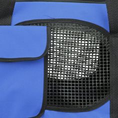 the back side of a blue backpack with black mesh pocket and zippers on it